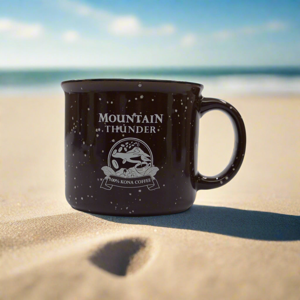 burgandy ceramic campfire style mug with black and white speckles, white interior, black rim and pink mountain thunder logo