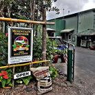 entrance of mountain thunder coffee plantation with 100lb sack full of coffee