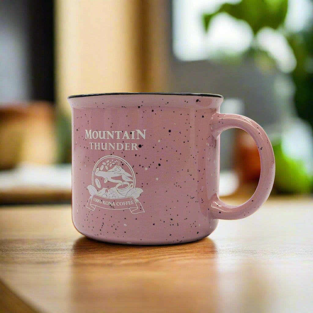 pink ceramic campfire style mug with black and white speckles, white interior, black rim and pink mountain thunder logo