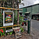 entrance of mountain thunder coffee plantation with 100lb sack full of coffee