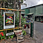 entrance of mountain thunder coffee plantation with 100lb sack full of coffee