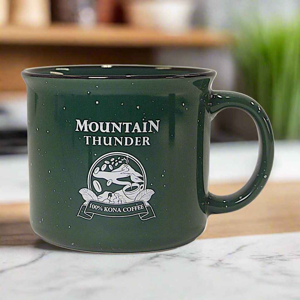 dark green ceramic campfire style mug with white speckles, black rim and mountain thunder logo