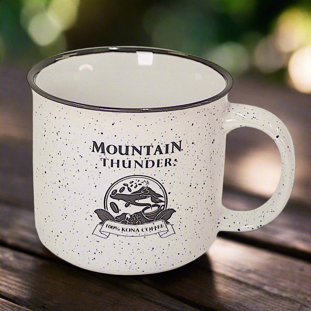 white ceramic campfire style mug with black speckles and lip with mountain thunder logo