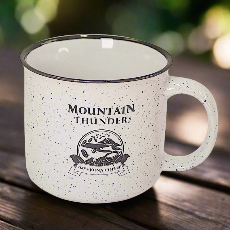 white ceramic campfire style mug with black speckles and lip with mountain thunder logo