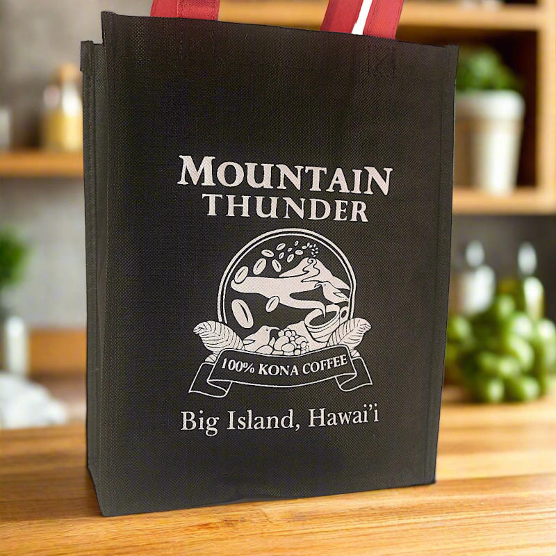 close view of black small tote with red handles and white mountain thunder logo